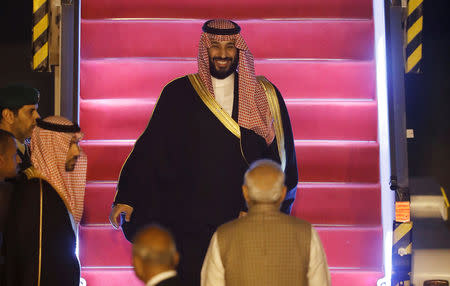 Saudi Arabia's Crown Prince Mohammed bin Salman disembarks from an aircraft as India's Prime Minister Narendra Modi looks on upon his arrival at an airport in New Delhi, India, February 19, 2019. REUTERS/Adnan Abidi