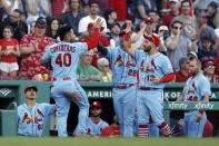 St. Louis Cardinals' Willson Contreras (40) celebrates with Juan Yepez (13) and Jack Flaherty (22) after scoring on a throwing error by Boston Red Sox's Enrique Hernandez during the ninth inning of a baseball game, Saturday, May 13, 2023, in Boston. (AP Photo/Michael Dwyer)