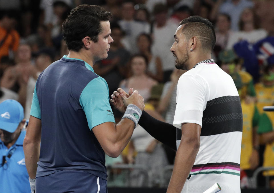 Canada's Milos Raonic, left, is congratulated by Australia's Nick Kyrgios after winning their first round match at the Australian Open tennis championships in Melbourne, Australia, Tuesday, Jan. 15, 2019. (AP Photo/Aaron Favila)