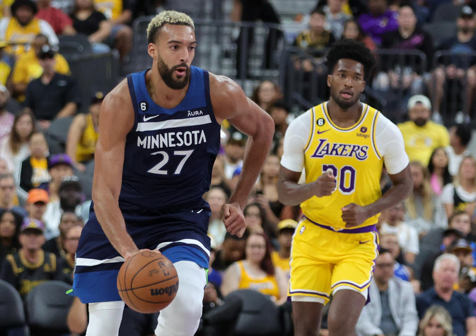 LAS VEGAS, NEVADA - OCTOBER 06: Rudy Gobert #27 of the Minnesota Timberwolves brings the ball up the court ahead of Damian Jones #30 of the Los Angeles Lakers in the second quarter of their preseason game at T-Mobile Arena on October 06, 2022 in Las Vegas, Nevada. The Timberwolves defeated the Lakers 114-99. NOTE TO USER: User expressly acknowledges and agrees that, by downloading and or using this photograph, User is consenting to the terms and conditions of the Getty Images License Agreement. (Photo by Ethan Miller/Getty Images)