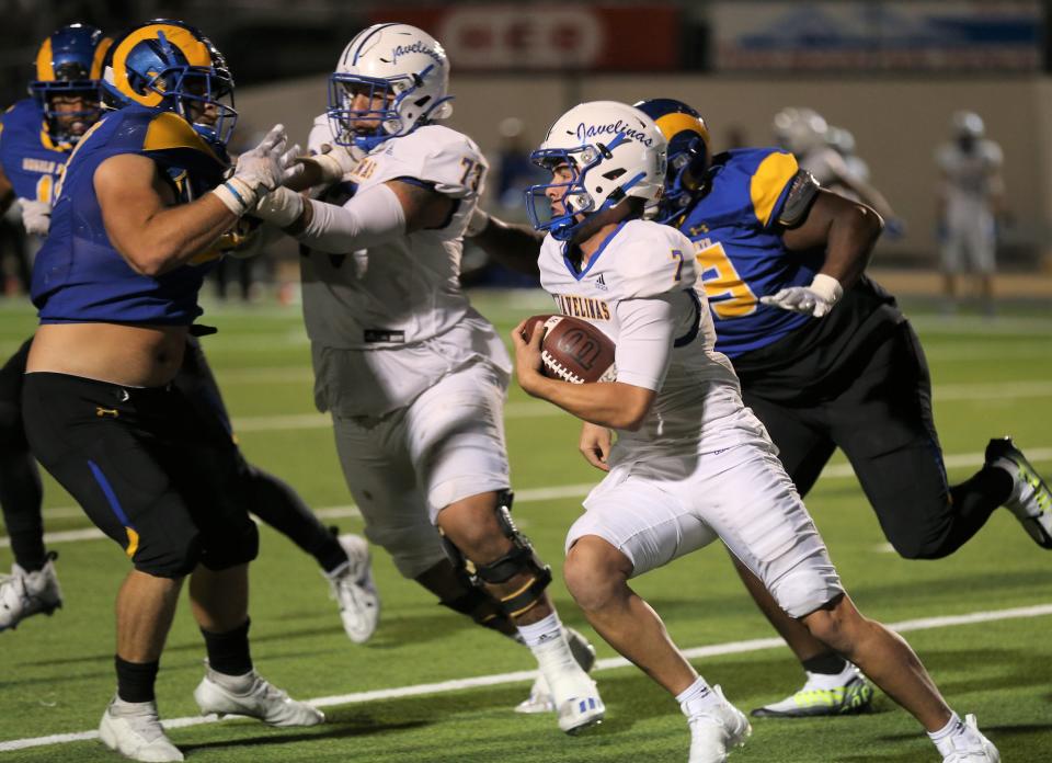 Texas A&M-Kingsville quarterback Jacob Cavazos, 7, fights for yardage during a Lone Star Conference football game against Angelo State University at 1st Community Credit Union Field at LeGrand Stadium on Saturday, Oct. 22, 2022.