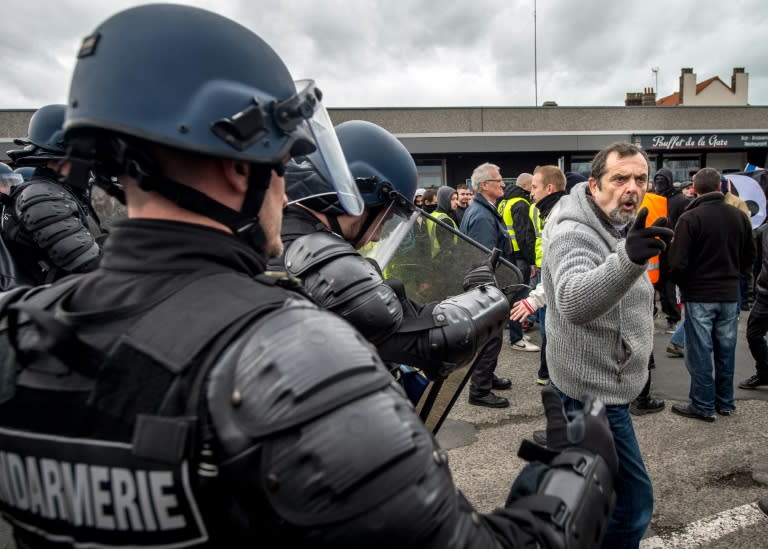 Policemen disperse supporters of the Pegida movement (Patriotic Europeans Against the Islamisation of the Occident) during a demonstration in Calais, northern France on February 6, 2016