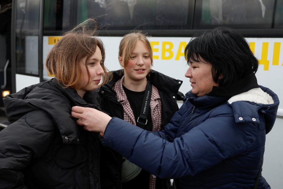 Natalia Rakk speaks with her 14-year-old daughters Dasha and Aliona, who went to a Russian-organised summer camp from non-government controlled territories and were then taken to Russia, after returning via the Ukraine-Belarus border in Volyn region, Ukraine April 7, 2023. REUTERS/Valentyn Ogirenko