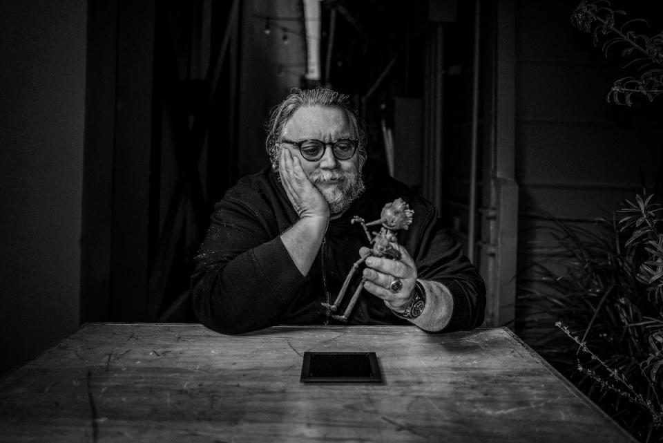 Guillermo Del Toro playing with a claymation figure