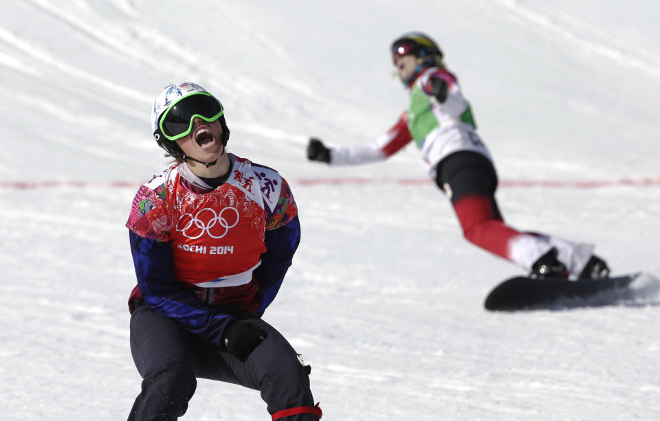 Czech Republic's Eva Samkova, left, celebrates after taking the gold medal in the women's snowboard cross final, ahead of silver medalist Dominique Maltais of Canada, right, at the Rosa Khutor Extreme Park, at the 2014 Winter Olympics, Sunday, Feb. 16, 2014, in Krasnaya Polyana, Russia. (AP Photo/Andy Wong)