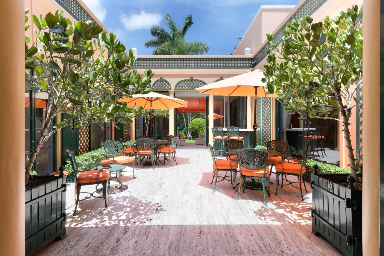 With dining tables for entertaining, the outdoor courtyard can be accessed from several rooms at a Palm Beach house at 309 Chapel Hill Road, which sold for $15.5 million.