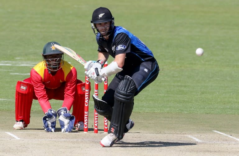 New Zealand captain Kane Williamson (R) plays a shot as Zimbabwe wicketkeeper Regis Chakabva looks on during the first in a three-match one-day international series at the Harare Sports Club in Harare on August 2, 2015