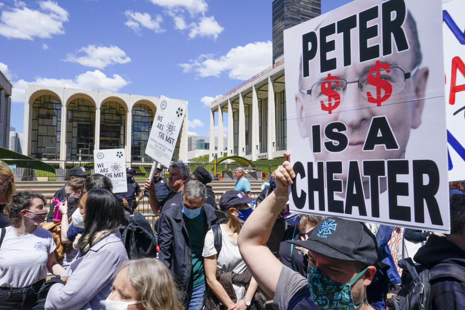 Union member demonstrators rally outside the Metropolitan Opera house during a "We Are the Met Rally," Thursday, May 13, 2021, in New York. Locked out stagehands and unions with contracts expiring this summer demonstrated outside the Met to protest the Opera's unfair treatment of workers, lockout of stagehands and the outsourcing of work. (AP Photo/Mary Altaffer)