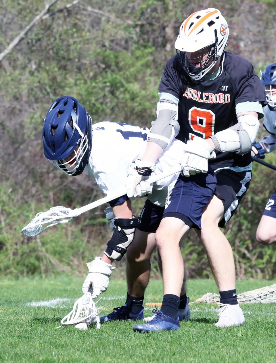 Rockland's Tyler Boehner cradles the ball next to Middleboro defender Andrew Small during a game on Wednesday, April  27, 2022.  