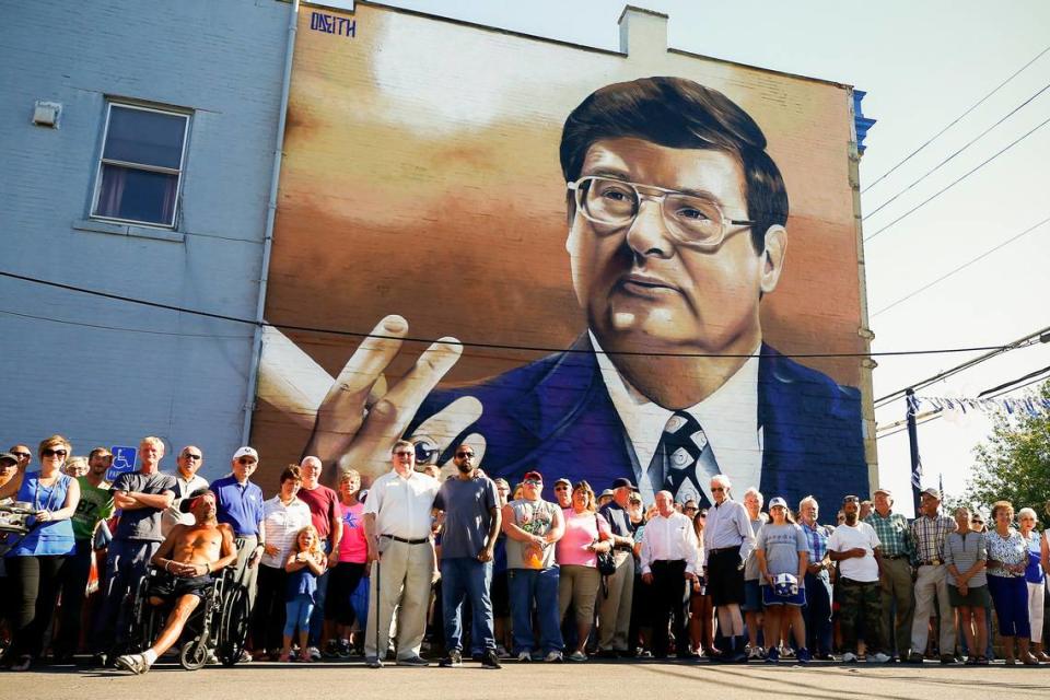 Former University of Kentucky head basketball coach Joe B. Hall posed for a picture with friends, family members and fans in front of a mural featuring his image in downtown Cynthiana in 2017.