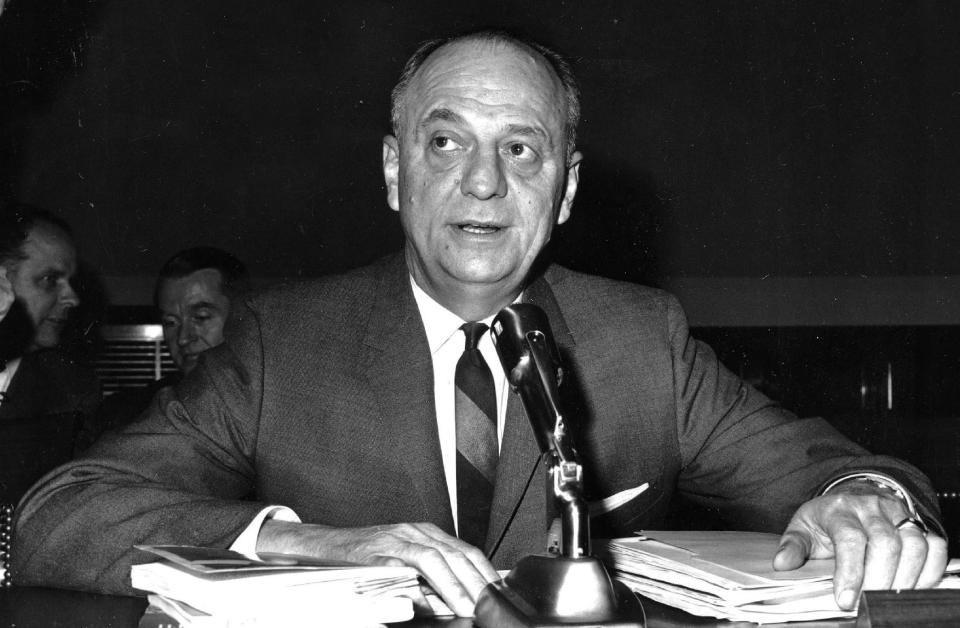 FILE - In this April 9, 1965 file photo, Surgeon General Luther Terry testifies on Capitol Hill in Washington before the House Commerce Committee hearing on proposed labeling of cigarette packages. It's no secret that smoking causes lung cancer. But what about diabetes, rheumatoid arthritis, erectile dysfunction? Fifty years into the war on smoking, scientists still are adding diseases to the long list of cigarettes' harms _ even as the government struggles to get more people to kick the habit. A new report from the U.S. Surgeon General's office says the nation is at a crossroads, celebrating decades of progress against the chief preventable killer but not yet poised to finish the job.(AP Photo, File)