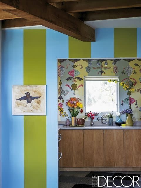 <p>In designer Todd Oldham's country home, sky-blue striped walls contrast with sage and chartreuse glaze on the wall behind the kitchen sink, which is further decorated with cutouts of <a rel="nofollow noopener" href="https://www.elledecor.com/design-decorate/room-ideas/g12446706/kitchen-wallpaper/?slide=7" target="_blank" data-ylk="slk:Japanese silk-screened papers;elm:context_link;itc:0;sec:content-canvas" class="link ">Japanese silk-screened papers</a>.</p>