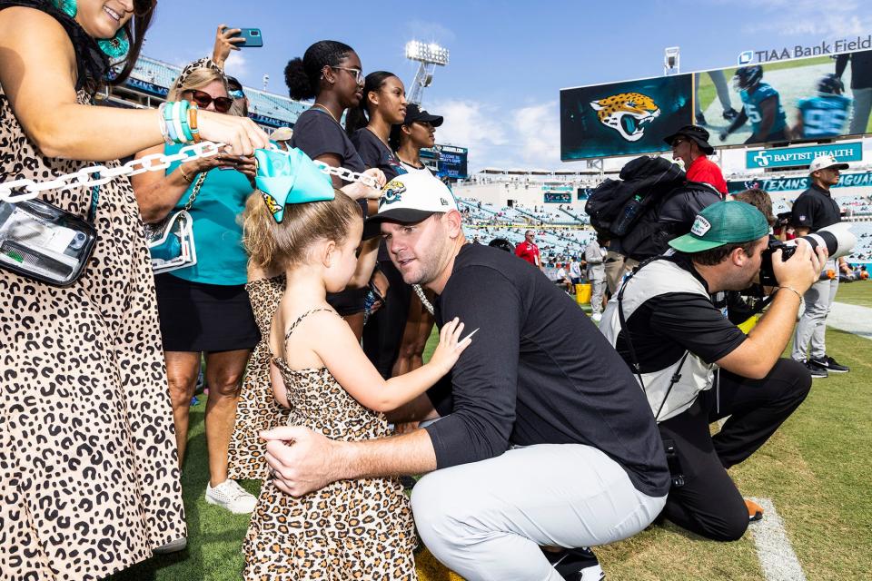 Jaguars offensive coordinator Press Taylor talks with his youngest daughter, Carolina Leigh, before last year's home game against the Houston Texans.