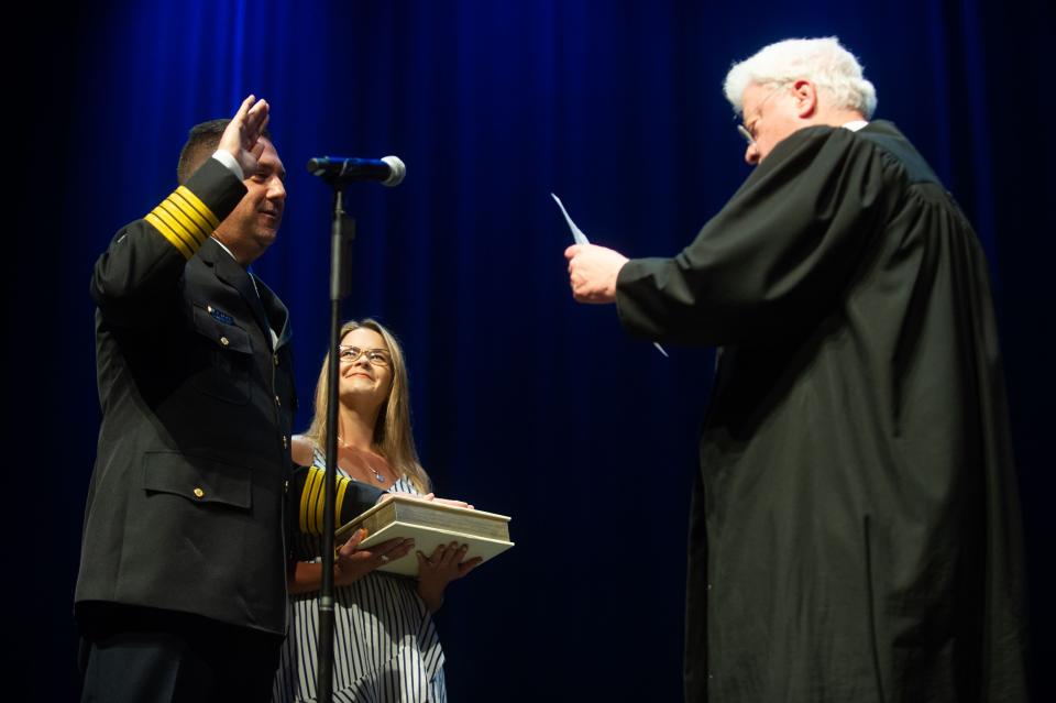 Judge John Rosson administers the oath of office to new Police Chief Paul Noel during his swearing-in ceremony at the Knoxville Coliseum on Monday.