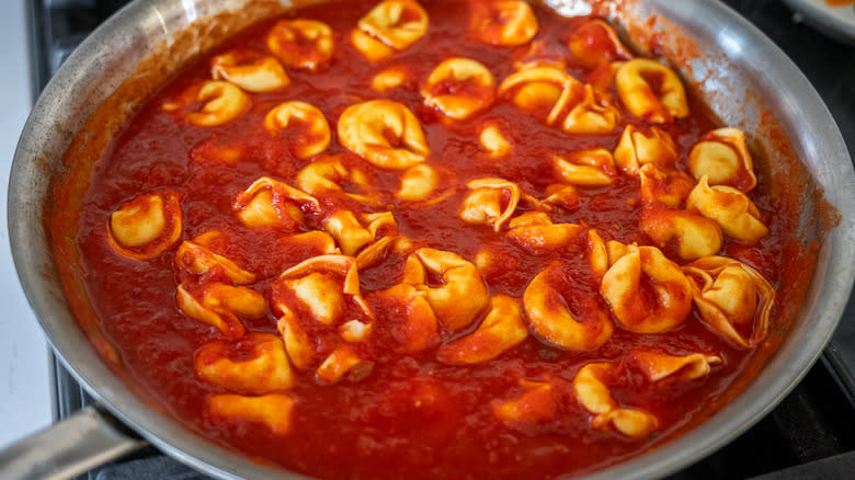 tortellini mixed with red sauce