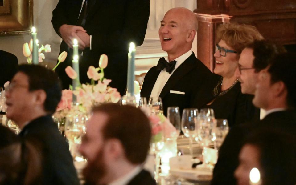 Big Tech moguls Tim Cook and Jeff Bezos (pictured), who was joined by Lauren Sanchez, were also in attendance (AFP via Getty Images)