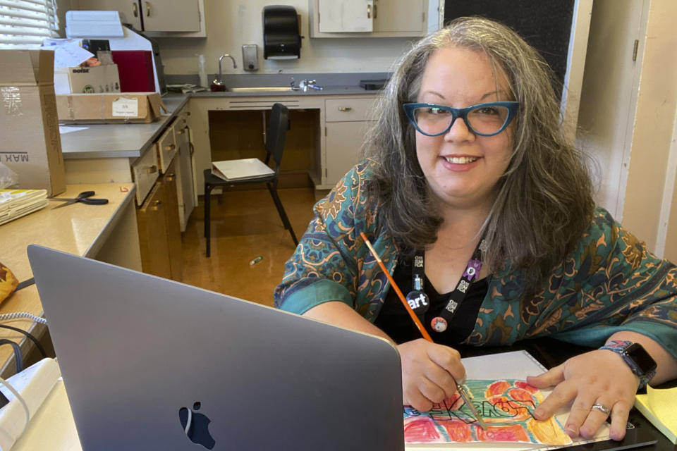 Middle school art teacher Rebecca Recco poses for a photo in her classroom Thursday, May 20, 2021, in Oakland, Calif. When Recco moved from Belle, W.Va., in 2017, she received a substantial pay increase as a teacher. West Virginia has seen a higher percentage of residents depart than any other state in the past decade. (Rebecca Recco via AP)