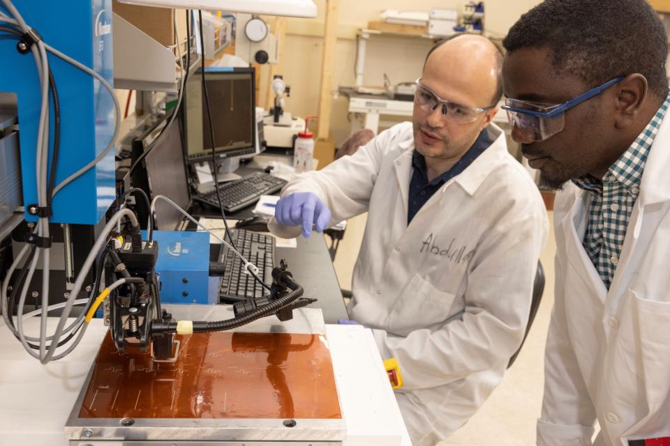 PhD students Abdullah Obeidat and Babatunde Falola do research at the Smart Electronics Manufacturing Lab at Binghamton University's Innovative Technologies Complex.