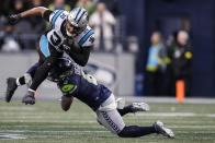 Carolina Panthers running back Chuba Hubbard (30) is hit by Seattle Seahawks safety Quandre Diggs (6) during the second half of an NFL football game, Sunday, Dec. 11, 2022, in Seattle. (AP Photo/Gregory Bull)