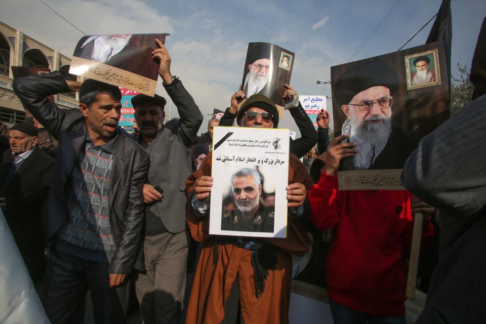 Iranians holds posters of Iran's supreme leader Ayatollah Ali Khamenei and Soleimani during a demonstration in Tehran. (Photo: ATTA KENARE via Getty Images)