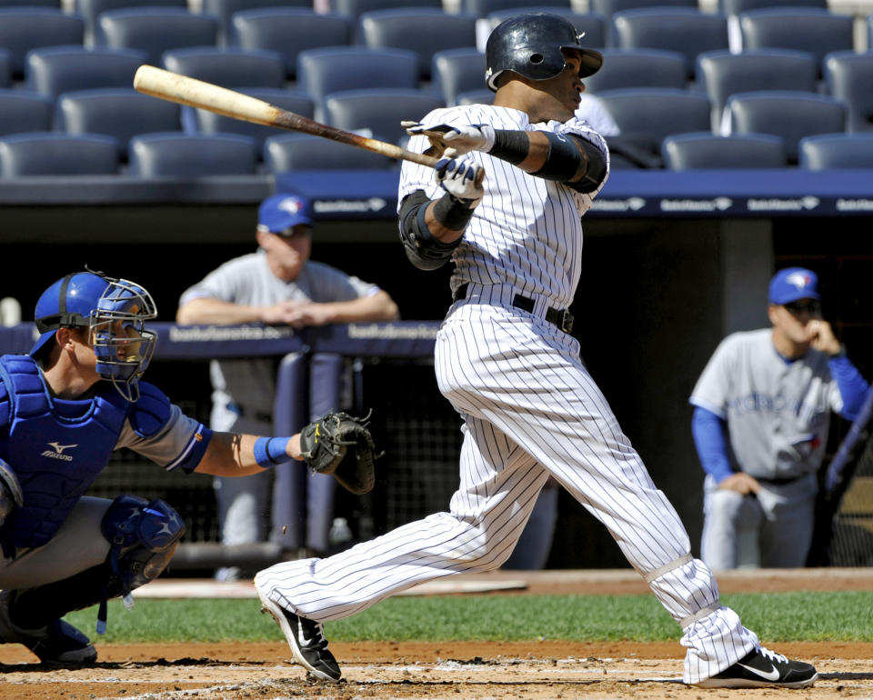 New York Yankees' Robinson Cano hits an RBI double during the first inning of the first baseball game of a doubleheader against the Toronto Blue Jays, Wednesday, Sept. 19, 2012, at Yankee Stadium in New York. The Yankees won 4-2. (AP Photo/Bill Kostroun)