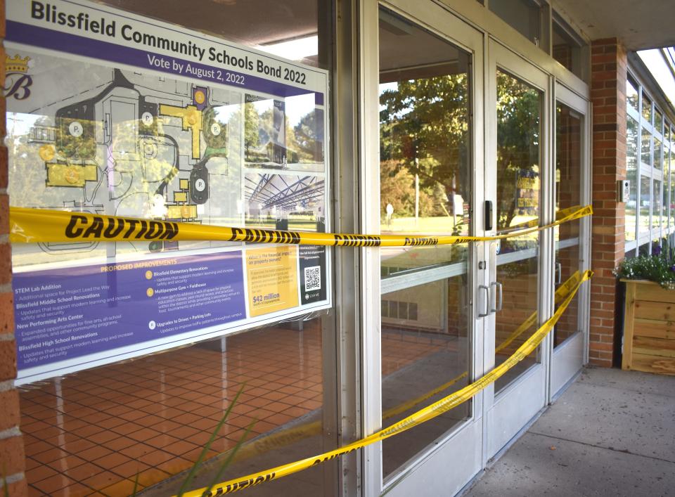 Caution tape is seen Saturday over the front entrance of Blissfield High School. Also at the entrance of the school is information regarding the district's Aug. 2 bond proposal.