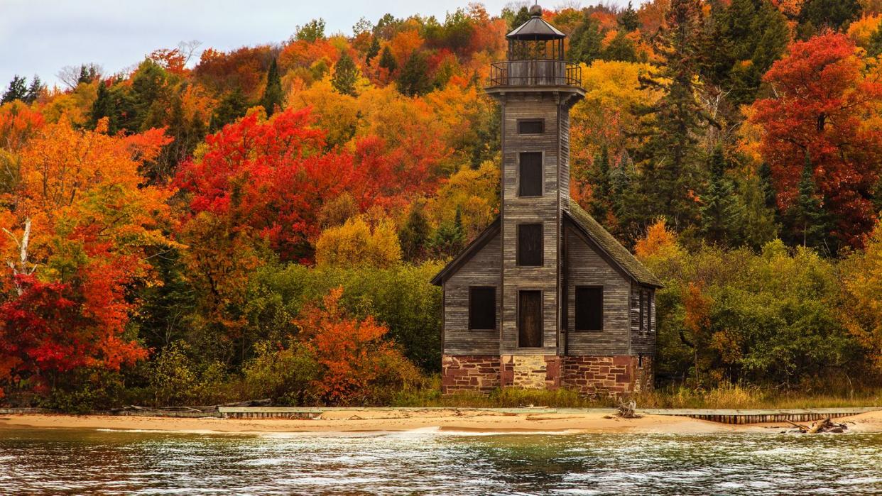 old wooden lighthouse next to lake superior, grand island, upper peninsula, michigan, usa