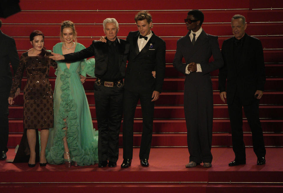 Priscilla Presley, from left, Olivia DeJonge, director Baz Luhrmann, Austin Butler, Alton Mason and Tom Hanks pose for photographers after departing the premiere of the film 'Elvis' at the 75th international film festival, Cannes, southern France, Wednesday, May 25, 2022. (AP Photo/Daniel Cole)