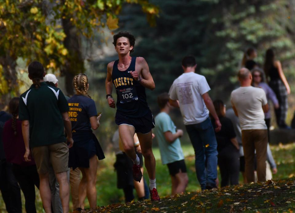 Div. 2 regional champion Nate Carmody of Haslett has a significant lead just past the one-mile mark, Friday, Oct. 27, 2023, during the MHSAA Div. 2 Cross Country regional at DeWitt High School. He finished with a time of 16:11.7.