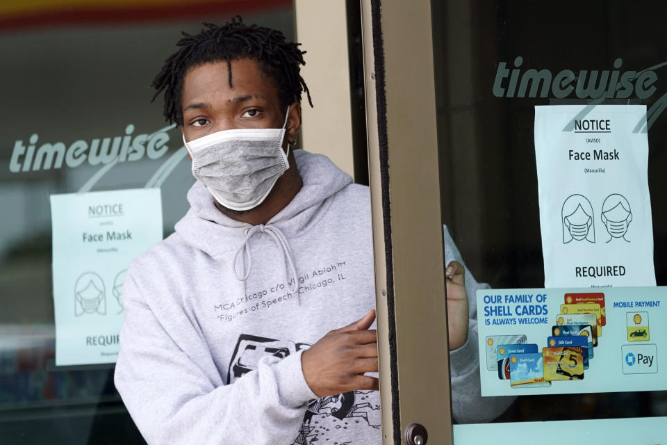 FILE - A man leaves a convenience store while wearing a required face mask in Houston, in this Thursday, June 25, 2020, file photo. Although nearly a fifth of U.S. states don't require people to wear masks to protect against COVID-19, some businesses are requiring employees and customers to be masked on their premises. (AP Photo/David J. Phillip, File)