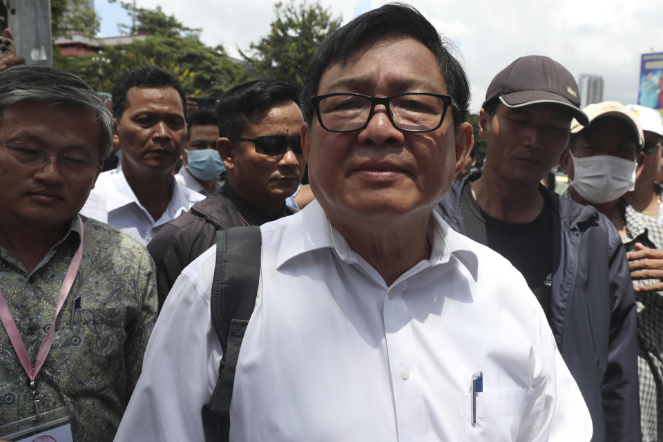 Son Chhay, center, deputy leader of the opposition political Candlelight Party, talks to the media in front of the Phnom Penh Municipal Court in Phnom Penh, Cambodia, Friday, Oct. 7, 2022. The court issued a defamation verdict against Son Chhay on Friday in the case filed by National Election Committee. (AP Photo/Heng Sinith)