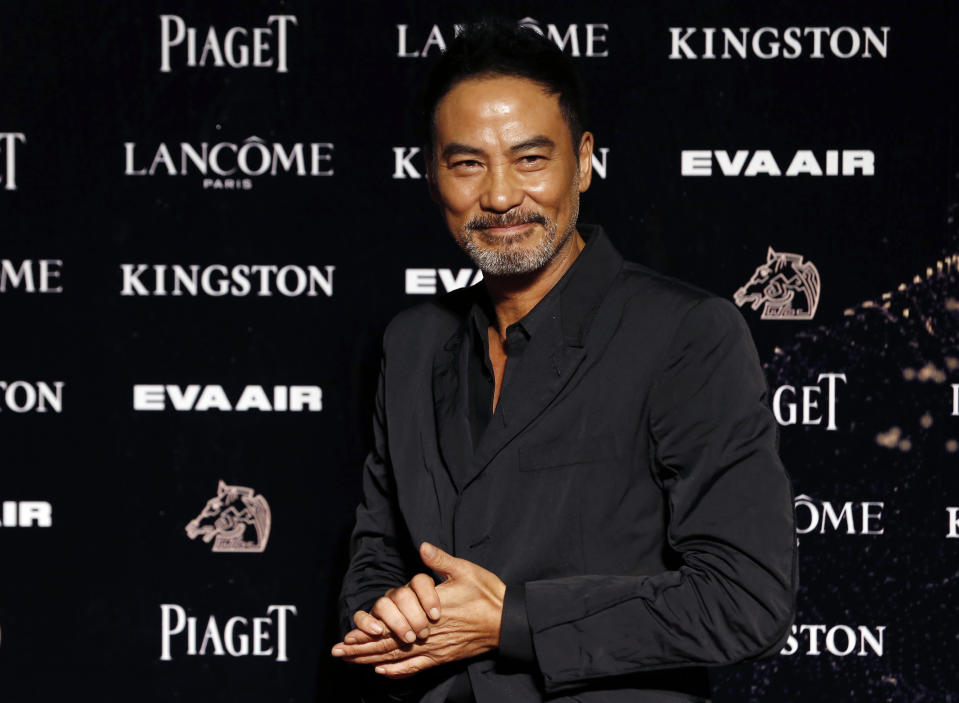 FILE - In this Nov. 21, 2015, file photo, Hong Kong actor Simon Yam poses on the red carpet at the 52nd Golden Horse Awards in Taipei, Taiwan. Veteran Hong Kong actor Simon Yam has been stabbed while attending an event in southern China. Police say his injuries are not life-threatening and a suspect has been detained. The motive is unclear. (AP Photo/Wally Santana, File)