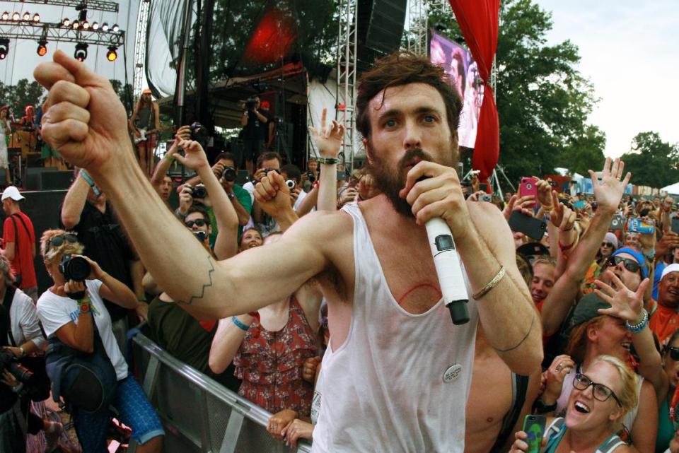 FILE - In this June 16, 2013 file photo, Alex Ebert of Edward Sharpe and the Magnetic Zeros performs on Day 4 of the 2013 Bonnaroo Music and Arts Festival in Manchester, Tenn. The 2014 season of music festivals is upon us. It’s easy to get caught up in the excitement and spend a bundle, on everything from tickets to accommodations to bottles of water. But with a little foresight, it’s easy to cut down on excess spending and enjoy the music and excitement without breaking the bank. (Photo by Wade Payne/Invision/AP, File)