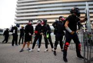 Demonstrators stand behind barricades during a protest in Hong Kong