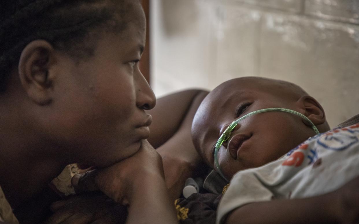 A mother in Democratic Republic of Congo looks on as her child is treated for pneumonia – Luc responded well to his treatment and is set to make a good recovery - Jonathan Hyams/Save the Children