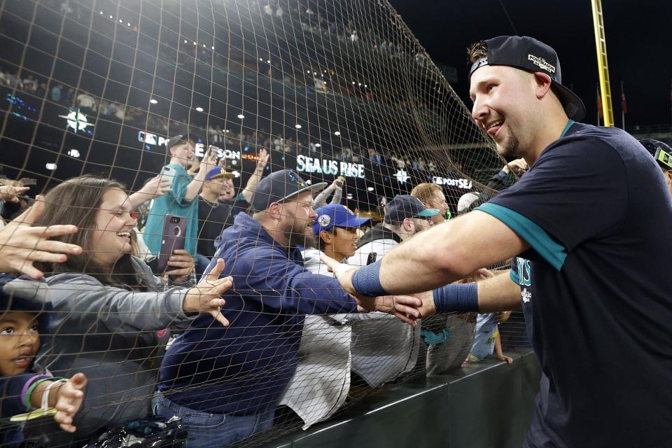 SEATTLE, WASHINGTON - SEPTEMBER 30: Cal Raleigh #29 of the Seattle Mariners celebrates after a walk-off home run during the ninth inning against the Oakland Athletics at T-Mobile Park on September 30, 2022 in Seattle, Washington. With the win, the Seattle Mariners have clinched a postseason appearance for the first time  in 21 years, the longest playoff drought in North American professional sports. (Photo by Steph Chambers/Getty Images)