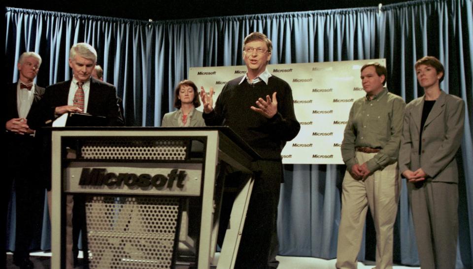 REDMOND, UNITED STATES:  Microsoft Chairman Bill Gates (3rd R), surrounded by his top executives, responds at a press conference 07 June, 2000 in Redmond, WA to the Justice Department's ruling. The breakup of Microsoft, ordered 07 June by a federal judge, is subject to appeal. Microsoft has vowed to aggressively challenge all aspects of the ruling by Judge Thomas Penfield Jackson, who ordered the breakup after finding that the company had abused the monopoly position of its Windows personal computer operating systems to stifle competition. AFP PHOTO/Dan LEVINE (Photo credit should read DAN LEVINE/AFP via Getty Images)