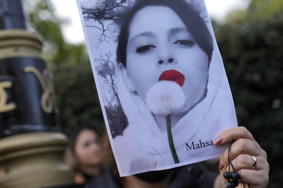 FILE - Demonstrators hold placards outside the Iranian Embassy in London, Sunday, Sept. 25, 2022. As anti-government protests roil cities and towns in Iran for a fourth week, sparked by the death of a 22-year-old woman detained by Iran's morality police, tens of thousands of Iranians living abroad have marched on the streets of Europe, North America and beyond in support of what many believe to be a watershed moment for their home country. (AP Photo/Alastair Grant, File)