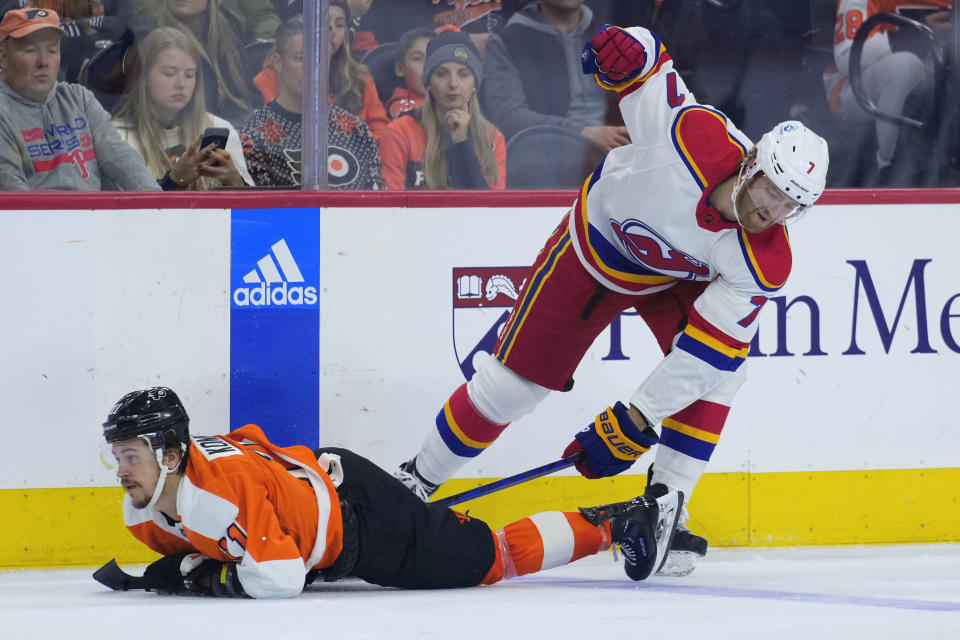 Philadelphia Flyers' Travis Konecny, left, collides with New Jersey Devils' Dougie Hamilton during the third period of an NHL hockey game, Saturday, Dec. 3, 2022, in Philadelphia. (AP Photo/Matt Slocum)