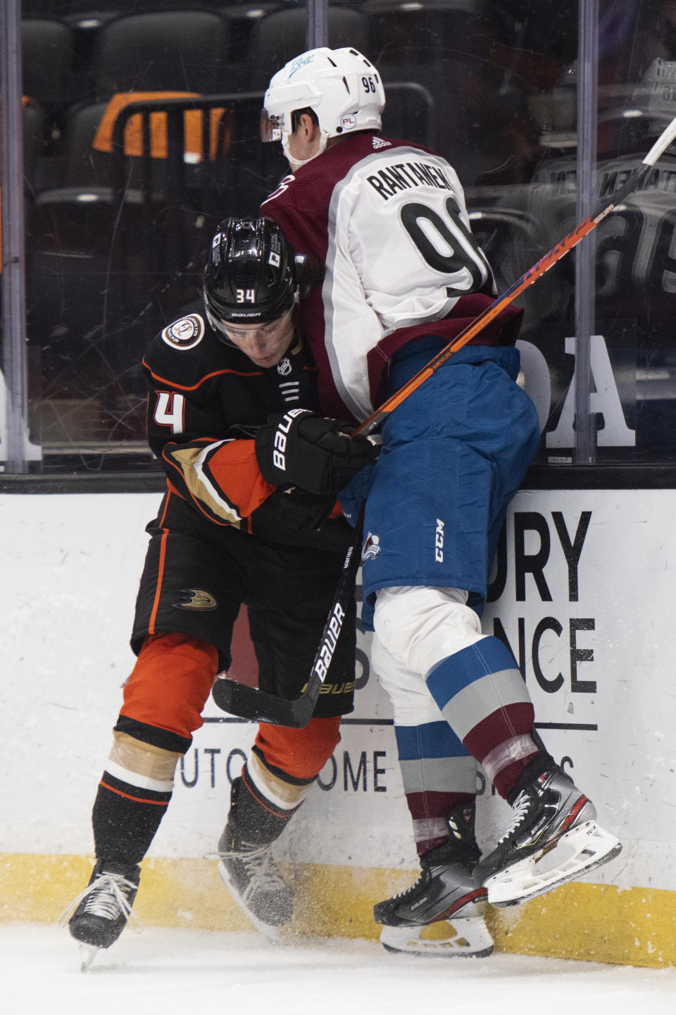 Anaheim Ducks defenseman Jamie Drysdale, left, body checks Colorado Avalanche right wing Mikko Rantanen in the first period of an NHL hockey game in Anaheim, Calif., Sunday, April 11, 2021. (AP Photo/Kyusung Gong)