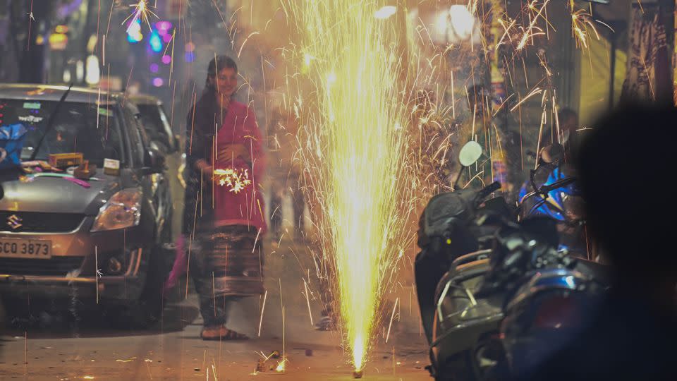 New Delhi residents burst firecrackers on Diwali despite a nationwide ban to curb pollution levels on November 12, 2023. - Raj K Raj/Hindustan Times/Getty Images