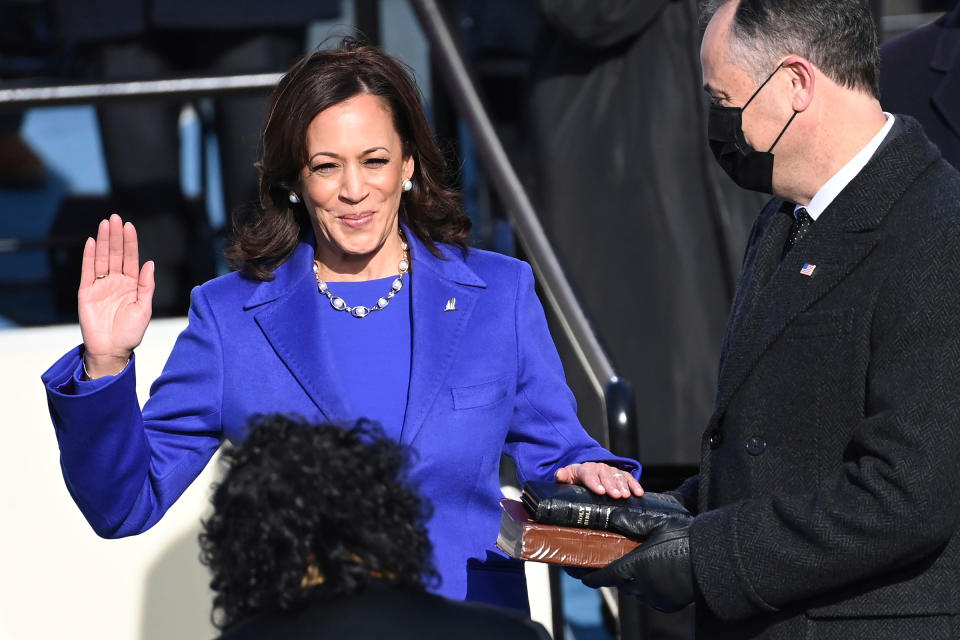 Kamala Harris is sworn in as vice president by Supreme Court Justice Sonia Sotomayor as her husband Doug Emhoff holds the Bible.<span class="copyright">Saul Loeb—Pool/AP</span>