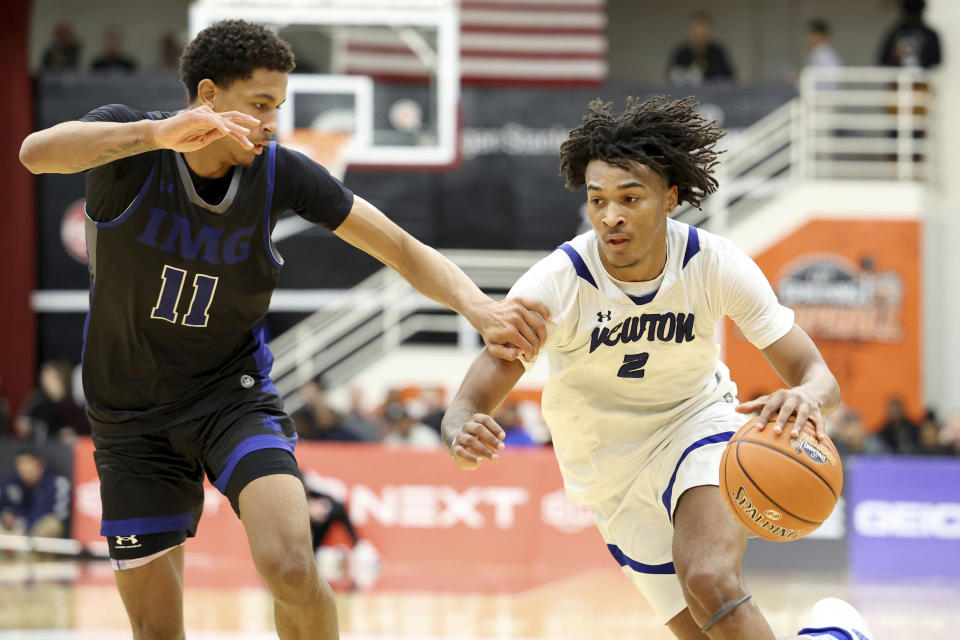 FILE - Newton's Stephon Castle, right, dribbles against IMG Academy during a high school basketball game at the Hoophall Classic, Saturday, Jan. 14, 2023, in Springfield, Mass. Castle arrives at UConn regarded as a potential NBA lottery pick after being ranked as the nation’s No. 9 overall prospect in his class according to composite rankings of recruiting sites compiled by 247Sports. (AP Photo/Gregory Payan, File0