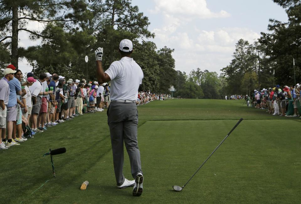 Tiger Woods of the U.S. drops his driver after hitting off the ninth tee and sending the ball onto the first fairway during first round play of the Masters golf tournament at the Augusta National Golf Course in Augusta, Georgia April 9, 2015. REUTERS/Mark Blinch