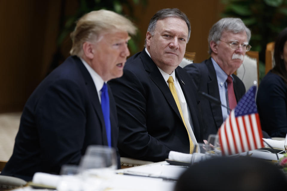 Secretary of State Mike Pompeo, center, and national security adviser John Bolton, right, listen as President Donald Trump speaks during a meeting with Vietnamese Prime Minister Nguyen Xuan Phuc at the Office of Government Hall, Wednesday, Feb. 27, 2019, in Hanoi. (AP Photo/ Evan Vucci)