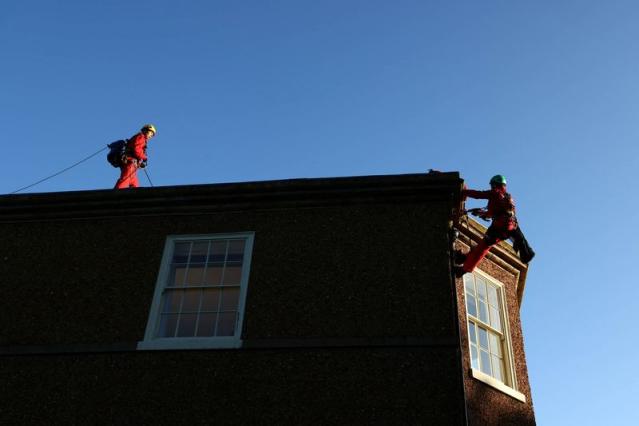 Protesters drape home of UK PM Sunak in black fabric over oil policy