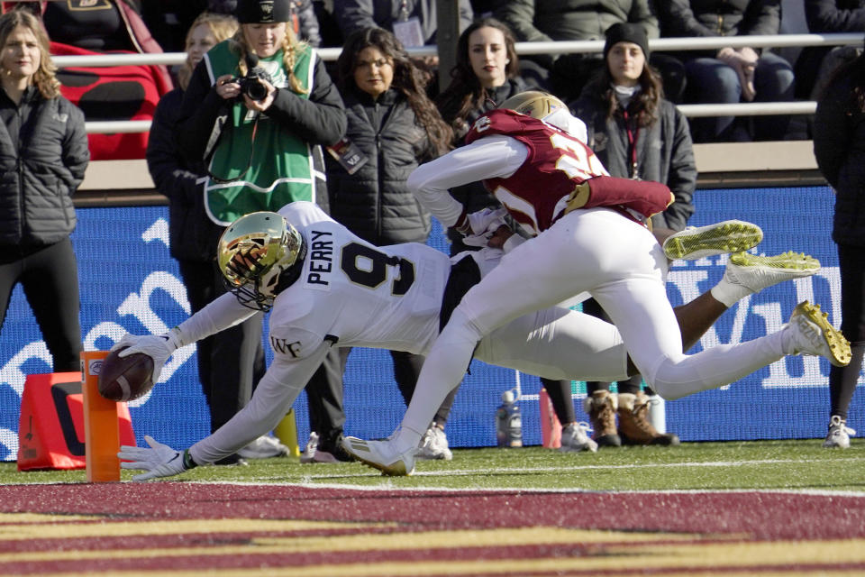 Wake Forest wide receiver A.T. Perry (9) dives for the pylon to score a touchdown ahead of Boston College defensive back Elijah Jones (20) during the first half of an NCAA college football game, Saturday, Nov. 27, 2021, in Boston. (AP Photo/Mary Schwalm)