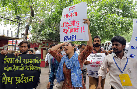 A woman shouts slogans as she holds up a placard during a protest to demand Electronic Voting Machines (EVM) numbers be tallied with Voter-Verified Paper Audit trail (VVPAT) machines numbers, outside the office of the Election Commission of India in New Delhi, India, May 22, 2019. REUTERS/Anushree Fadnavis