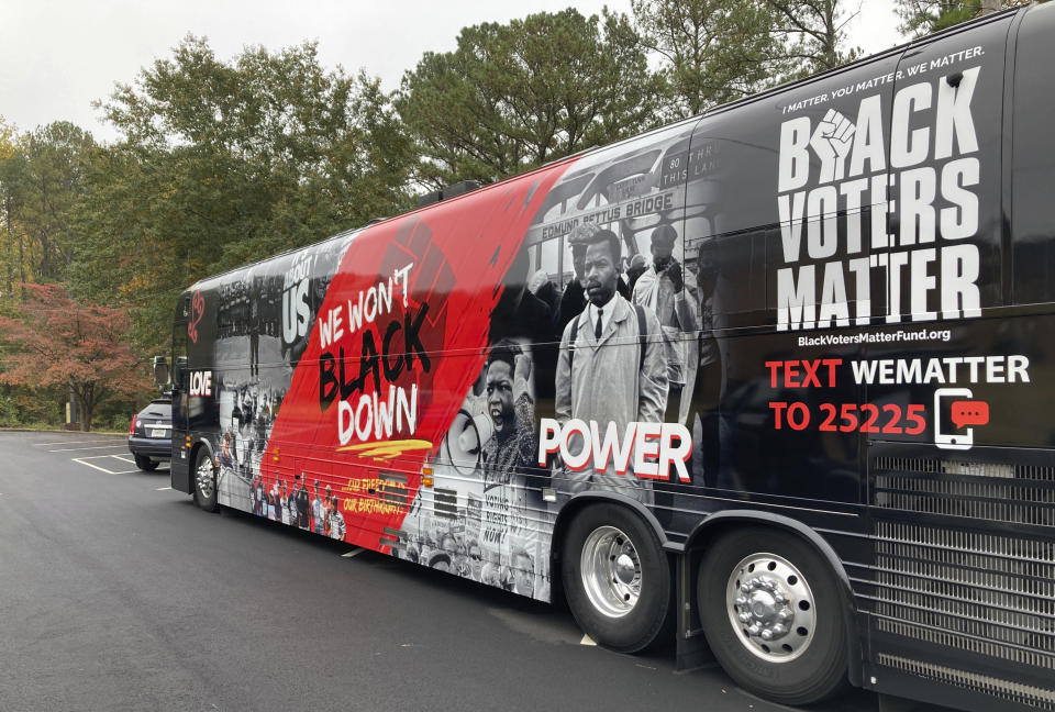 A bus waits to take voters to the polls as part of a Black church tradition known as "Souls to the Polls," in Decatur, Ga., Sunday, Oct. 30, 2022. (AP Photo/Sudhin Thanawala)