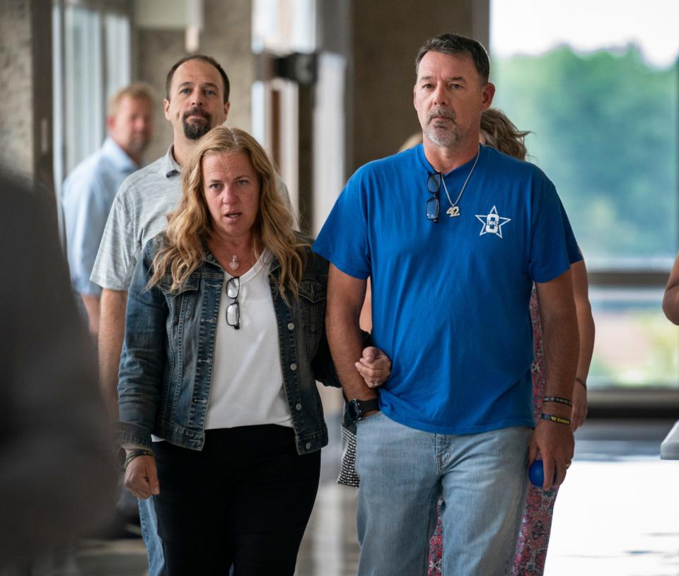 Sheri and Buck Myre, parents of slain Oxford student Tate Myre, make their way to a hearing held at the Oakland County Courthouse on Thursday, July 27, 2023, to determine whether Ethan Crumbley will serve a life sentence for the Oxford School shootings where he murdered four students including Tate, and injured seven others in the 2021 shooting spree.